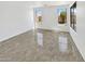An open-concept living room is bathed in natural light from large windows and features tile floors at 3013 S 102Nd Ln, Tolleson, AZ 85353
