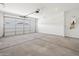 Spacious two car garage with new concrete flooring and white walls at 37126 W Prado St, Maricopa, AZ 85138