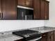 Close-up of a kitchen, highlighting the gas stove and granite countertops at 37126 W Prado St, Maricopa, AZ 85138