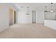 Open concept living area with tile flooring, leading to kitchen and patio at 37126 W Prado St, Maricopa, AZ 85138