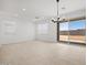 Open living room with tile floors, recessed lighting, and sliding glass doors at 37126 W Prado St, Maricopa, AZ 85138