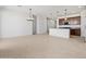 Spacious living area with tile flooring, seamlessly connected to modern kitchen at 37126 W Prado St, Maricopa, AZ 85138