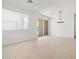 Bright living room featuring tile floors, large windows, and modern lighting at 37126 W Prado St, Maricopa, AZ 85138