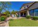 Large backyard with built-in grill, dining table, sitting area and lush artificial turf at 3751 E Zachary Dr, Phoenix, AZ 85050