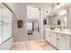 Bright bathroom with double sinks, white cabinets, and view to bedroom area, offering ample space at 3751 E Zachary Dr, Phoenix, AZ 85050