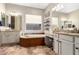 Luxurious bathroom featuring dual vanities, a soaking tub, and elegant tile work at 3751 E Zachary Dr, Phoenix, AZ 85050