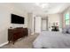 Spacious bedroom features a ceiling fan, dresser with TV, and cozy carpet for ultimate relaxation at 3751 E Zachary Dr, Phoenix, AZ 85050