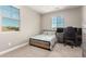 Well-lit bedroom featuring two large windows, neutral walls and carpet, and a gray bed at 3751 E Zachary Dr, Phoenix, AZ 85050