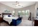 Comfortable bedroom with a plush king-sized bed, many windows and a ceiling fan at 3751 E Zachary Dr, Phoenix, AZ 85050