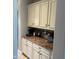 A home coffee bar with cabinets and a countertop with two coffee makers and assorted coffee accompaniments at 3751 E Zachary Dr, Phoenix, AZ 85050