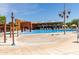 Beautiful community pool and spa area with poolside lounge chairs and umbrellas at 3751 E Zachary Dr, Phoenix, AZ 85050