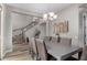 Formal dining room with wood floors, a modern chandelier, and a view of the staircase at 3751 E Zachary Dr, Phoenix, AZ 85050
