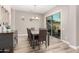 Neutral dining room features wood floors, chandelier, and sliding glass doors to outside at 3751 E Zachary Dr, Phoenix, AZ 85050
