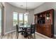 Dining room featuring wood floors, a modern light fixture, and a large window overlooking the backyard at 3751 E Zachary Dr, Phoenix, AZ 85050