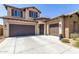 Charming two-story home with a three-car garage, stone accents, and a well-maintained front yard at 3751 E Zachary Dr, Phoenix, AZ 85050