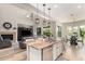 Well-designed kitchen island with granite counters, a sink, and stainless steel appliances adjoining the living room at 3751 E Zachary Dr, Phoenix, AZ 85050