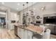 Stylish kitchen with granite counters, stainless appliances, central island, and open access to the living room at 3751 E Zachary Dr, Phoenix, AZ 85050