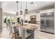 Open kitchen boasts stainless steel appliances, granite counters, pendant lighting, and an island with seating at 3751 E Zachary Dr, Phoenix, AZ 85050