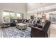 Spacious open-concept living room with plush seating, large windows, and seamless flow to the kitchen area at 3751 E Zachary Dr, Phoenix, AZ 85050