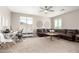 Spacious living room with large windows, a comfortable leather sofa, and a neutral color palette at 3751 E Zachary Dr, Phoenix, AZ 85050
