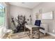 Bright home office space featuring a modern desk, exercise bike, and natural light from the window at 3751 E Zachary Dr, Phoenix, AZ 85050