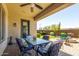 Covered patio with elegant furniture, offering a relaxing outdoor dining and entertainment space at 3751 E Zachary Dr, Phoenix, AZ 85050