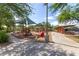 Community playground with slides, swings, and covered seating areas under mature shade trees at 3751 E Zachary Dr, Phoenix, AZ 85050