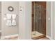 Modern walk-in shower with a glass enclosure and stylish wood-look tile at 3751 E Zachary Dr, Phoenix, AZ 85050