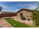 A quaint backyard with a built-in bocce ball court and outdoor fireplace area at 42311 W Bunker Dr, Maricopa, AZ 85138