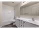 Well-lit bathroom featuring a vanity with sink, mirror, and shower-tub combo at 42311 W Bunker Dr, Maricopa, AZ 85138
