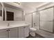 Clean bathroom with white vanity, toilet, and shower with glass doors at 42311 W Bunker Dr, Maricopa, AZ 85138