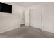 Simple bedroom with closet, tv, neutral paint and carpet at 42311 W Bunker Dr, Maricopa, AZ 85138