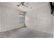 Spacious bedroom with ceiling fan, neutral paint and carpet at 42311 W Bunker Dr, Maricopa, AZ 85138