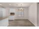 View of the open dining room with laminate floors and neutral paint at 42311 W Bunker Dr, Maricopa, AZ 85138