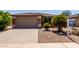 Charming home featuring a two-car garage, desert landscaping, and a red tile roof at 42311 W Bunker Dr, Maricopa, AZ 85138