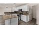 Updated kitchen with stainless appliances, white cabinets, and granite counters at 42311 W Bunker Dr, Maricopa, AZ 85138