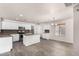 Spacious kitchen with white cabinetry, granite countertops, and a large island at 42311 W Bunker Dr, Maricopa, AZ 85138
