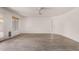 Bright living room with laminate floors, a ceiling fan, and a sliding glass door at 42311 W Bunker Dr, Maricopa, AZ 85138