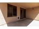 The covered patio features a concrete paver flooring and leads out to the backyard at 42311 W Bunker Dr, Maricopa, AZ 85138