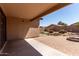 The outdoor covered patio features a concrete paver flooring and leads out to the backyard at 42311 W Bunker Dr, Maricopa, AZ 85138