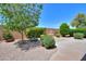 Charming backyard featuring lush greenery, mature trees, and a decorative water fountain, perfect for outdoor relaxation at 426 N Santiago Trl, Casa Grande, AZ 85194