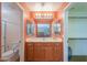 This is a bathroom with a single sink vanity, storage, lighting, and tile floors at 426 N Santiago Trl, Casa Grande, AZ 85194