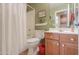 Bathroom with light wooden vanity, framed mirror, and shower-tub combination at 426 N Santiago Trl, Casa Grande, AZ 85194