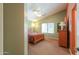 This bedroom features neutral colored walls and carpet, wood furnishings, and bright natural light at 426 N Santiago Trl, Casa Grande, AZ 85194