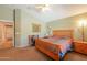 A view of the bedroom with neutral paint, carpet, light wood furniture, and a desk area at 426 N Santiago Trl, Casa Grande, AZ 85194
