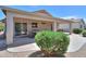 A spacious covered patio with outdoor dining set, sliding glass door, and manicured landscaping, perfect for entertaining at 426 N Santiago Trl, Casa Grande, AZ 85194