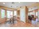 Warm dining area with tile floors, a breakfast nook with a bay window, and entry to the living room at 426 N Santiago Trl, Casa Grande, AZ 85194