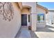 Home entrance featuring a covered porch, secure front door and desert landscaping at 426 N Santiago Trl, Casa Grande, AZ 85194