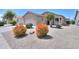 Single-story home featuring a two-car garage and low-maintenance desert landscaping at 426 N Santiago Trl, Casa Grande, AZ 85194