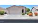 Charming single-story home showcasing a well-maintained front yard with a spacious two-car garage at 426 N Santiago Trl, Casa Grande, AZ 85194